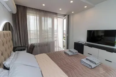 a bedroom with a bed with two towels on it at Gran Capital Top Central Apartment in Sofia