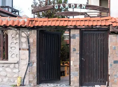 an entrance to a building with a black gate at Cosy room in the center of Bansko in Bansko