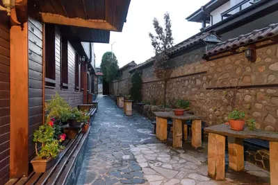an alley with benches and plants in a building at Cosy room in the center of Bansko in Bansko
