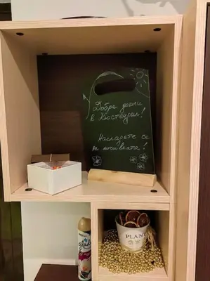 a chalkboard in a cabinet with a mortar and pestle at Alexander Apartments Kyustendil in Kyustendil