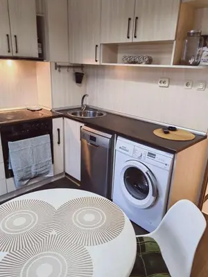 a kitchen with a washing machine and a sink at Alexander Apartments Kyustendil in Kyustendil