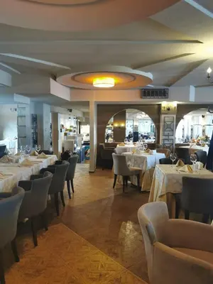 a dining room with white tables and chairs at Suite Roma 1 at Royal Spa in Velingrad