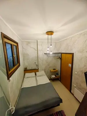 a small room with a bed and a window at My place - 24h Self Check-in in Sofia