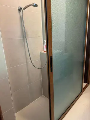 a shower with a glass door in a bathroom at My place - 24h Self Check-in in Sofia