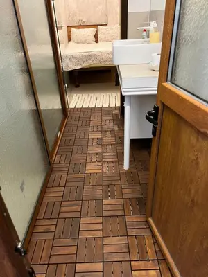 a bathroom with a wooden floor and a sink at My place - 24h Self Check-in in Sofia