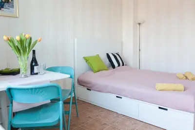 a bedroom with a bed and a table and chairs at Tony's Sunny Rooftop Studio by Flat Mаnager in Sofia