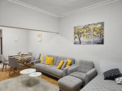 a living room with a couch and a table at Spacious Aristocratic Apt. with a Colourful View in Sofia