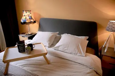 a bedroom with a bed with a table on it at *CITADEL* 2BR - city center in Sofia