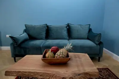 a bowl of fruit on a table in front of a couch at *CITADEL* 2BR - city center in Sofia