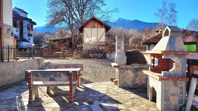 a patio with a pizza oven and a building at Large 2-bedroom apt near ski road, 5 min to Gondola & Bar Street in Bansko