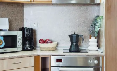 a kitchen with a microwave and a bowl of apples at Large 2-bedroom apt near ski road, 5 min to Gondola & Bar Street in Bansko