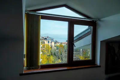 a window with a view of a city at Large 2-bedroom apt near ski road, 5 min to Gondola & Bar Street in Bansko