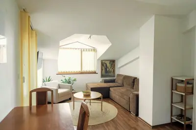 a living room with a couch and a table at Large 2-bedroom apt near ski road, 5 min to Gondola & Bar Street in Bansko