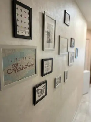 a wall with framed pictures on a wall at Elegant Stay in the Heart of Plovdiv Old Town in Plovdiv
