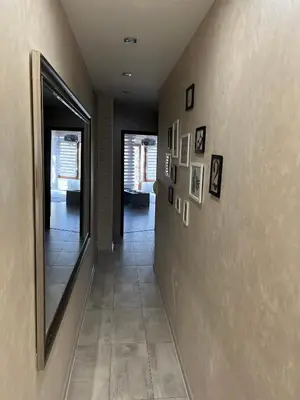 a hallway with a mirror and a tile floor at Elegant Stay in the Heart of Plovdiv Old Town in Plovdiv