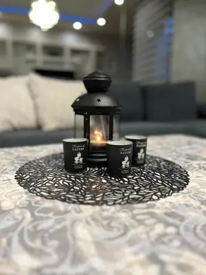 a table with a candle and three cups on it at Elegant Stay in the Heart of Plovdiv Old Town in Plovdiv
