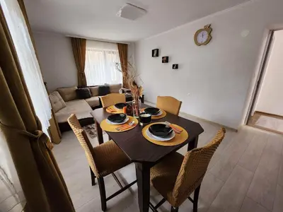 a dining room table and chairs in a living room at Апартамент за гости Криси гр. Девин in Devin