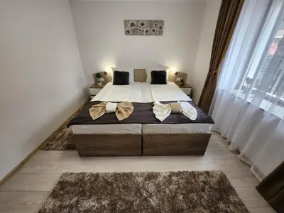 a bedroom with a large bed with two pillows at Апартамент за гости Криси гр. Девин in Devin