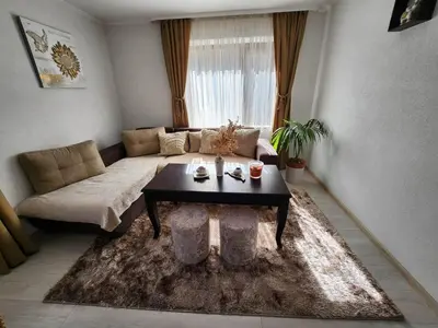 a living room with a couch and a coffee table at Апартамент за гости Криси гр. Девин in Devin