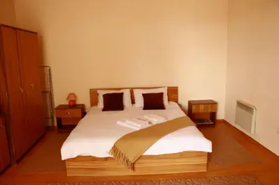 a bedroom with a large bed with white sheets and pillows at Pirin Palace in Bansko