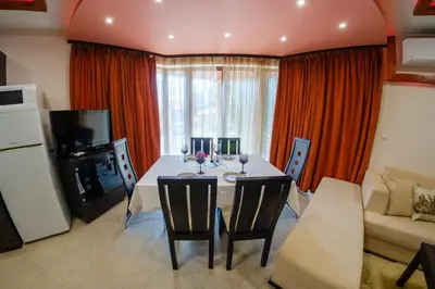 a living room with a table and a couch at Pamporovo Cottage Savov in Pamporovo