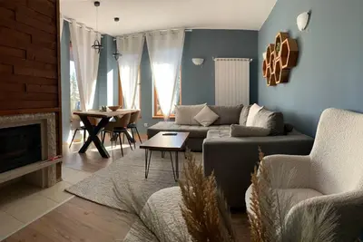 a living room with a couch and a table at Cozy Apartment B35 in Grand Resort Pamporovo in Pamporovo