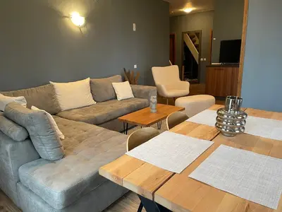 a living room with a couch and a table at Cozy Apartment B35 in Grand Resort Pamporovo in Pamporovo