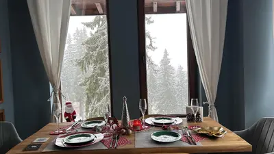 a dining room table with a santa claus christmas tablestrationmoilmoil at Cozy Apartment B35 in Grand Resort Pamporovo in Pamporovo