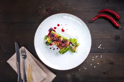 a white plate with food on a wooden table at Парк-Хотел Клементина in Trud