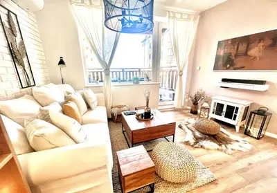 a living room with a white couch and a fireplace at Boutique lux design apartment @Bansko Royal Towers in Bansko
