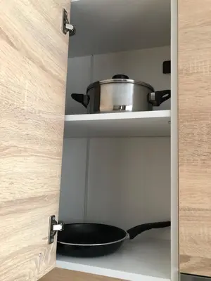 a pot and a pan sitting on a shelf in a kitchen at Luxury apartment 1 Free Underground Secure Parking in Pazardzhik