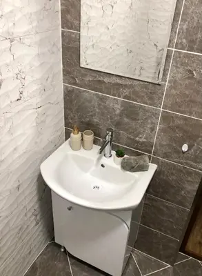 a bathroom with a white sink and a mirror at Luxury apartment 1 Free Underground Secure Parking in Pazardzhik