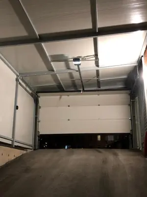 an empty parking garage with a large white garage door at Luxury apartment 2 Free Underground Secure Parking in Pazardzhik