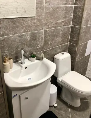 a bathroom with a white sink and a toilet at Luxury apartment 2 Free Underground Secure Parking in Pazardzhik