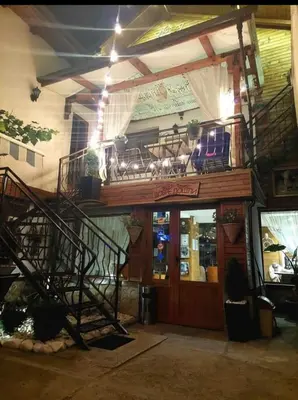 a restaurant with a balcony with chairs on top of it at NIKI HOUSE in Bansko