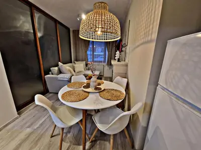 a small dining room with a white table and chairs at 1 bedroom luxury apartment Milena -free parking in Pamporovo