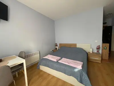 a bedroom with a bed with two towels on it at Your Place Borovets in Borovets