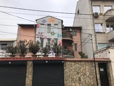 a building with flowers painted on the side of it at 10 Coins Hostel & tours in Sofia