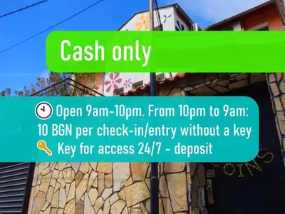 a green sign that says cash only on a street at 10 Coins Hostel & tours in Sofia