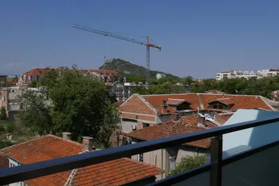 a view of a city from a balcony with roofs at Charmful new flat with Hill view in Plovdiv