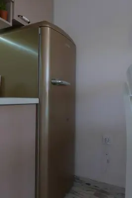 a stainless steel refrigerator in the corner of a kitchen at Charmful new flat with Hill view in Plovdiv