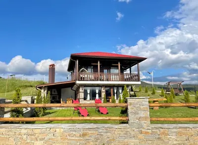 a house with a balcony on top of a fence at Villa ART in Dospat