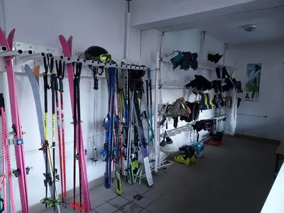a room with a bunch of skis hanging on a wall at 4 Seasons 2 - Top Lodge in Bansko