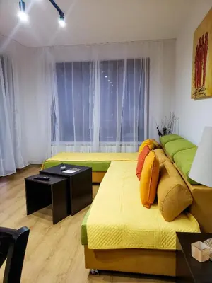 a living room with two beds and a table at Semiramida gardens Apartment 23 in Borovets