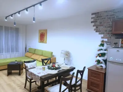 a living room with a table and a christmas tree at Semiramida gardens Apartment 23 in Borovets
