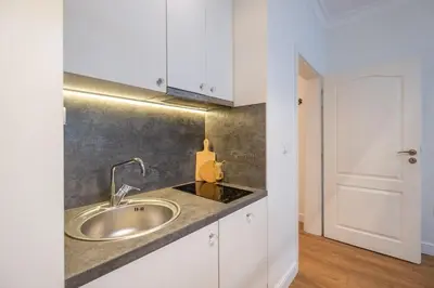 a bathroom with a sink and white cabinets at St. Ivan Rilski flat in Sofia