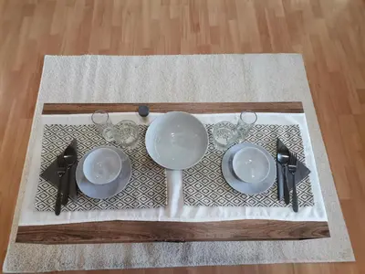 a table with plates and glasses on a table at Quiet central studio in Pazardzhik