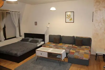 a living room with a couch and a bed at Quiet central studio in Pazardzhik