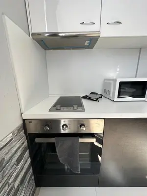 a kitchen with a stove and a microwave at Rose apt South Park - Free Public Parking, Mountain View, self check-in, near metro, stores, family-friendly in Sofia