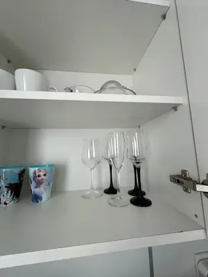 three wine glasses sitting on a shelf in a kitchen at Rose apt South Park - Free Public Parking, Mountain View, self check-in, near metro, stores, family-friendly in Sofia